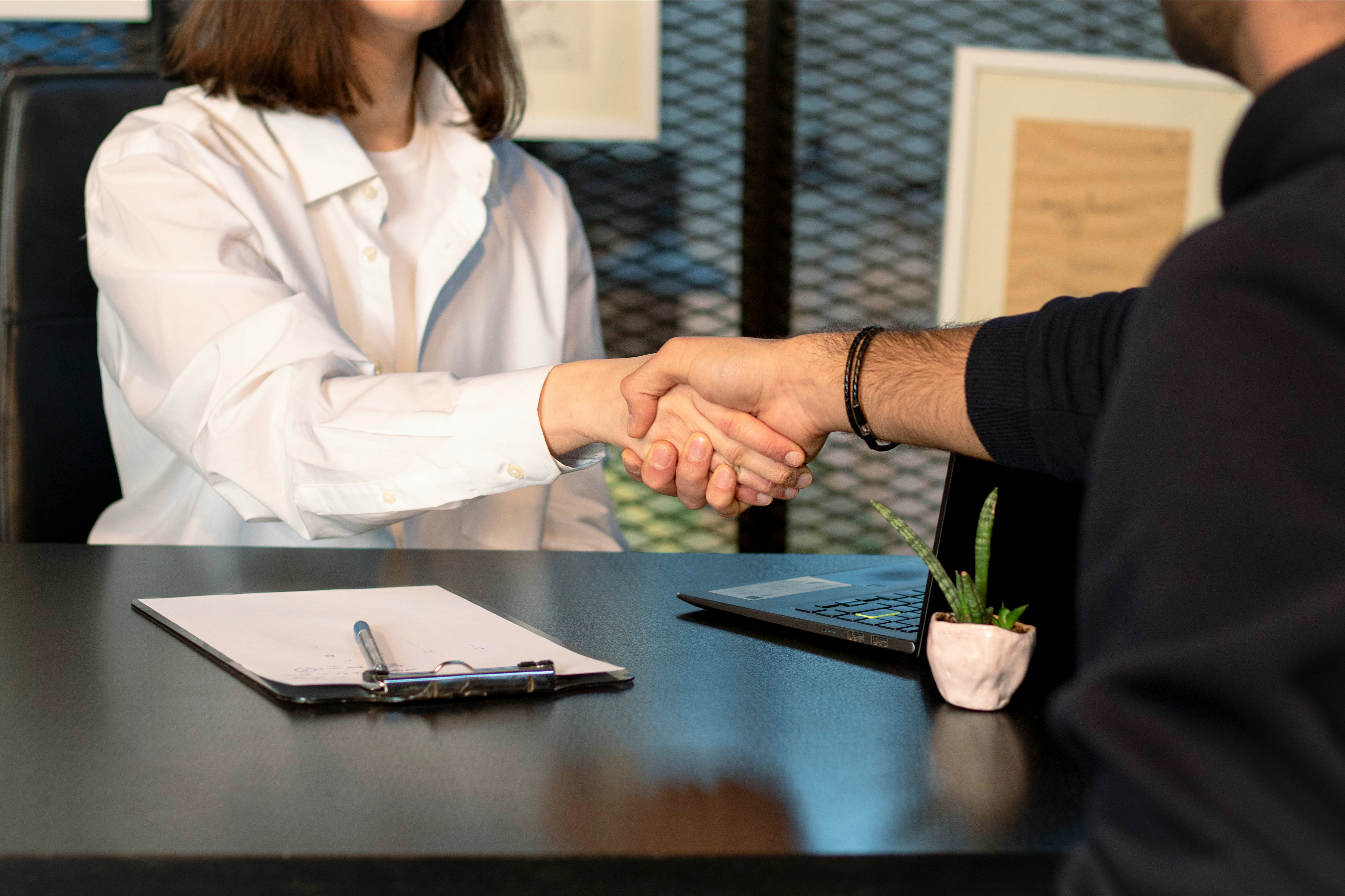 Advisor and client shaking hands after a consultation